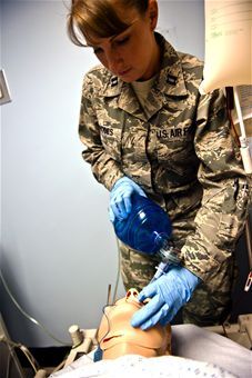 a woman in uniform is performing an operation