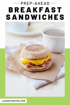 a breakfast sandwich with eggs, ham and cheese on a napkin next to a cup of coffee