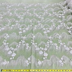 This exquisite Beaded 3D Floral Lace Fabric Embroidered on 100% Polyester Net Mesh is the perfect choice for creating unique, couture-level designs. Soft yet durable, this high quality fabric is beautifully crafted, adding texture and texture and dimension to your creations. From wedding dresses and bridal gowns to special occasion wear and dancewear, this fabric will make any design stand out. With its beading, pearls, and sequined accents, it will provide the perfect finishing touch. Shopping White Embroidered Fabric With Floral Applique For Party, White Embroidered Fabric With Appliques For Party, White Embroidered Fabric With Pearl Detail, Fitted Lace Fabric With 3d Embroidery, Elegant White Embroidered Fabric With 3d Embroidery, Elegant White Fabric With 3d Embroidery, Elegant White 3d Embroidered Fabric, White Embroidered Fitted Fabric, White Embroidered Party Fabric