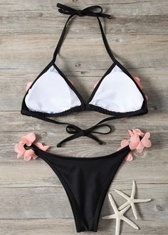 This Petals Trim Two-Piece Bikini Swimsuit is perfect for a day at the beach. Crafted with a pink and black color scheme, this swimsuit provides durability with its clorine-resisting fabric, resisting fading and wear for extended use. Show off your style in the sun with this unique two-piece bikini. Swimwear cannot be returned or exchanged. Black Triangle Top Swimwear For Summer, Stretch Black Swimwear For Beach, Black Stretch Beachy Swimwear, Black Tropical Swimwear For Poolside, Black Stretch Swimwear For Beach, Tropical Black Swimwear For Poolside, Black Beachy Swimwear For Sunbathing, Black Triangle Top Swimwear For Pool, Black Triangle Top Swimwear For Vacation