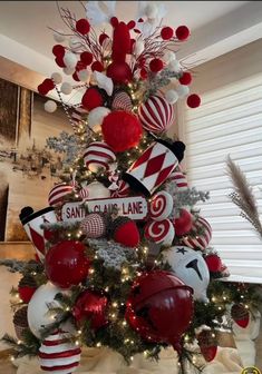 a christmas tree decorated with candy canes, ornaments and other holiday decorating items