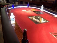 a red table topped with lots of bottles