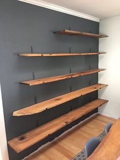 the shelves are made out of wood and have metal brackets on one side, while another shelf is built into the wall