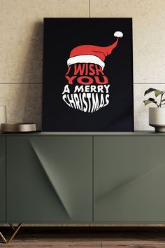 a black poster with the words wish you a merry christmas on it next to a sideboard