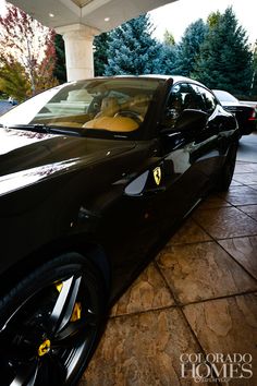 a black sports car parked in front of a building