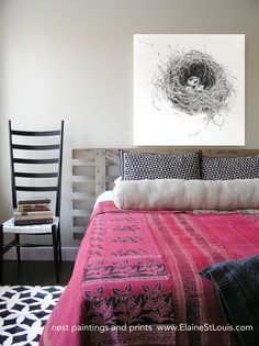 a bedroom with a bird's nest on the wall above the bed and chair