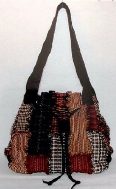 the purse is made out of fabric and has two straps on each side that are attached to