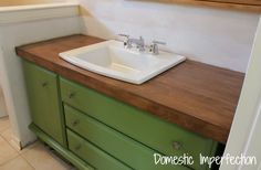 a bathroom sink sitting on top of a wooden counter