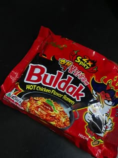 a bag of budak sitting on top of a black table next to a fork