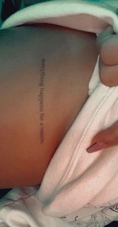 the back of a woman's stomach with an inscription on it