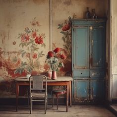 a table with two vases on top of it next to a chair and cabinet