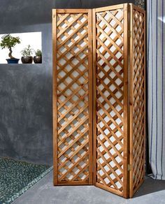 an outdoor room divider made out of wood