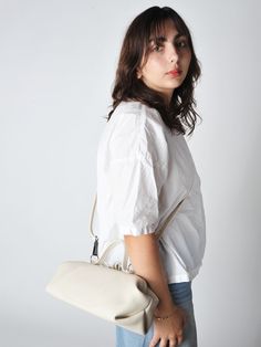 The baguette bag is a charming framed ladies bag. softly structured in a supple leather and lightweight it has a snap top closure and a detachable adjustable strap which allows for multiple carry options.    • handmade in utrecht the netherlands  • 14"l x 6"h x 5"d - unlined  • detachable adjustable shoulder strap 38" - smoke hardware  • 3.5" handles  • single snap top frame closure.  2 small drop down pockets on either side of the bag  • exclusive to roztayger in the us On-the-go Baguette Bag With Top Handle And Detachable Handle, Modern Everyday Satchel With Detachable Strap, Modern Satchel With Detachable Strap For Everyday, Modern Everyday Baguette Bag With Detachable Strap, Modern Baguette Bag With Detachable Strap For Everyday, Versatile Top Handle Baguette Bag For Travel, Versatile Everyday Box Bag With Detachable Strap, Chic Top Handle Baguette Bag For Travel, Timeless Everyday Flap Bag With Adjustable Strap