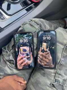 two people holding up their cell phones in the car