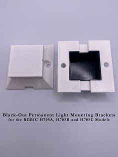 two white plastic mounting brackets with holes for the right and left side of each bracket