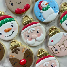 christmas cookies decorated with santa claus and snowmen on a marble countertop, top view