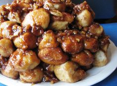 a pile of food sitting on top of a white plate covered in meat and sauce