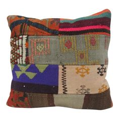 a multicolored patchwork pillow with different colors and patterns on it's sides