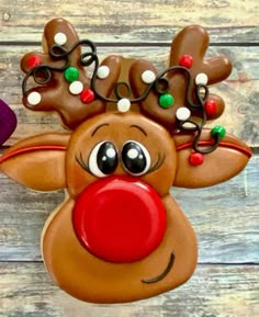 a close up of a reindeer head on a wooden surface