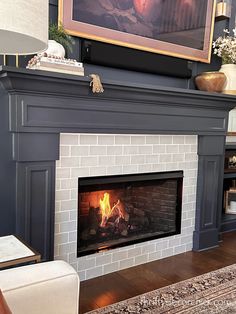 a fireplace with a painting on the wall above it