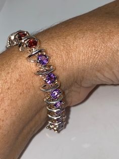 Vintage Garnet Amethyst Rhodium Finished Sterling Silver Tennis Bracelet The stones are deep colors and well matched. The sterling silver is plated with rhodium to protect the bracelet from tarnish This is longer bracket, 8 in All jewelry is shipped in a nice gift box. Check out our over a THOUSAND great reviews Engraving is $4 per letter and is not always perfect depending on the piece. It can take a few days if the jeweler is busy. This is payable to Paypal Judithsltd@gmail.com Silver Tennis Bracelet, Blue Topaz Bracelet, Topaz Stone, Deep Colors, Photo Bracelet, Tennis Bracelet, Chain Link Bracelet, Pandora Charm Bracelet, Chain Link