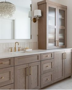 a bathroom vanity with two sinks and a large mirror over the sink in front of it