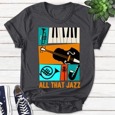 Jazz Musician Shirt, Jazz Music Tee, All That Jazz Shirt, Music Art Tee, Jazz T-Shirt, Jazz Tee, Jazz Lover Gift, Aestethic Tee B-10052230 *About Our Product: This smooth cotton T-shirt features double-needle stitching throughout the ribbed crewneck, straight hem, short sleeves, and a tag-free neck for everyday comfort. The tee is tailored from ultra-soft fabric and printed with the highest quality ink and modern technology so that the graphic is guaranteed to be durable over time. Its ultra-bre Music-themed Graphic Design T-shirt For Fans, Music-themed Graphic T-shirt For Fans, Music-themed Cotton T-shirt With Graphic Design, Music-themed Cotton T-shirt With Logo Print, Cotton Music-themed T-shirt With Text Print, Photoshop Tutorial Typography, Merch Design, Christmas Tshirt, Music Tees