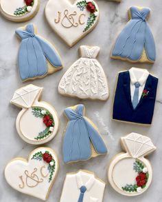 decorated cookies are arranged in the shape of wedding gowns and groom's ties