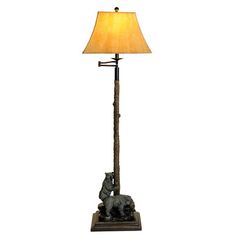 a lamp that is on top of a wooden base with a dog figurine underneath it