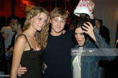 three young people posing for the camera at a party