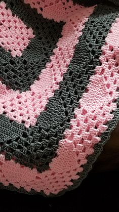 a crocheted blanket sitting on top of a wooden table