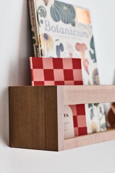 a book shelf with books on it and a checkerboard pattern in the front