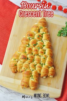 a wooden cutting board topped with bread christmas tree