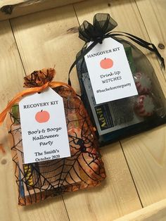 two bags of halloween treats sitting on top of a wooden table