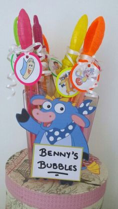 there is a cup that has some items in it on top of a stand with the name benny's bubbles