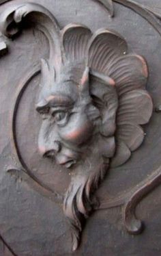 a close up of a metal door with a lion face on it's face