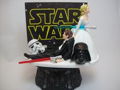 a star wars wedding cake topper with a darth vader and stormtrooper