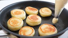 pancakes being cooked in a frying pan on the stove