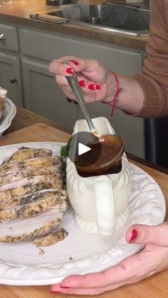 a woman is cutting up food on a plate