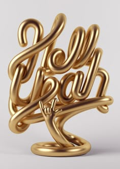 a gold sculpture with the word laugh on it