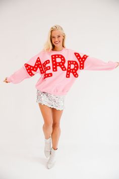 Spread holiday cheer in style with our Merry Star Pink Pullover! This playful pullover is perfect for any festive occasion, featuring bold red "Merry" cutout letters and shimmering silver star patches. Stay cozy and stand out in this quirky and fun pullover. All orders are currently shipping within 14 business days. To receive item quicker, expedited shipping is available at checkout. **All Christmas orders must be placed with expedited shipping to guarantee delivery by Dec. 24 if placed after D Merry And Bright Outfit, Funky Christmas Outfit, Trends Winter 2024, Pink And Red Christmas Aesthetic, Christmas Sweaters Ideas, Holiday Party Aesthetic, Wishlist Ideas Aesthetic, Pink Christmas Outfit, Holiday Fashion Editorial