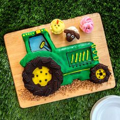 a cake shaped like a tractor with farm animals on it