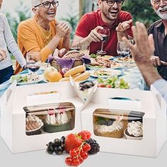 several people sitting around a table with food and drinks