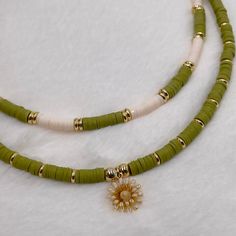 Heishi necklace, olive green necklace, Heishi boho necklace, dainty flower necklace, simple beaded necklace, summer bead necklace. These boho chic chokers are very trendy and they match with your daily outfit. If you are looking for stylish summer necklace to enhance your daily outfit, you found them! They're easy to wear everyday alone or layered with other favorite necklaces. 💕 ITEM DETAILS: Length: 14 - 16 inches. The length of the necklace refers to the total length from end-to-end. Materia Adjustable Green Flower Beaded Necklaces, Green Adjustable Flower Beaded Necklaces, Green Adjustable Necklace With Flower Charm, Green Flower Shaped Necklace With Beaded Chain, Dainty Green Adjustable Beaded Necklaces, Dainty Handmade Green Beaded Necklace, Green Flower Shaped Beaded Necklace, Green Flower-shaped Beaded Necklace, Green Heishi Bead Round Necklaces