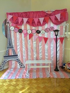 a pink and white stage set up with the eiffel tower in the background