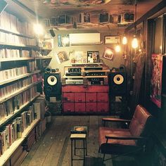 a room filled with lots of books and audio equipment