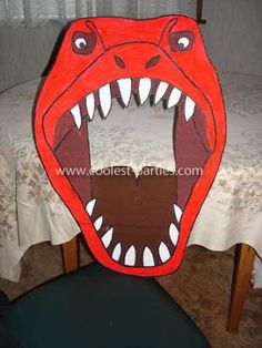 an image of a red monster head on top of a chair with it's mouth open