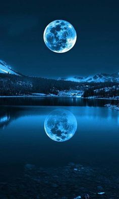 the moon is shining brightly in the night sky over a lake with trees and mountains