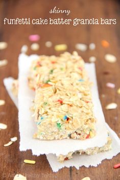 a close up of a piece of food on a table with confetti and sprinkles