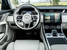 the interior of a car with dashboard, steering wheel and infotains on display